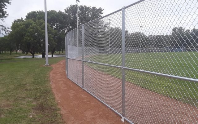 Baseball park fence financed by Twins / adult softball association grants set up at Johnson Field